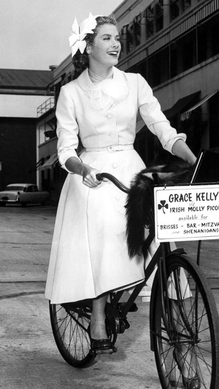 グレース Kelly bicycles to the soundstage of her latest Paramount picture, 1954