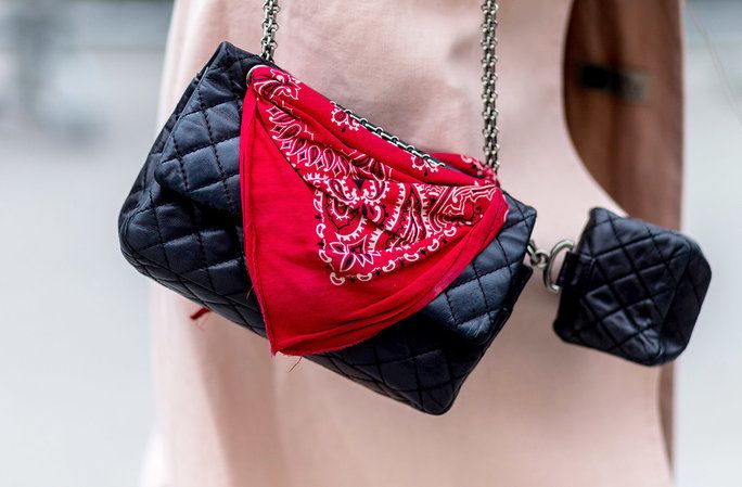 א bandana looped around the hardware of a ladylike bag gives the look rock-n-roll edge. 