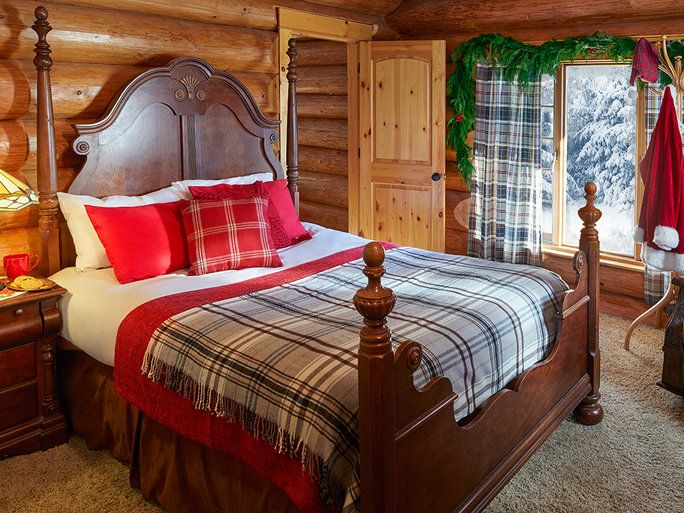 ה master bedroom looks out on the snowy woods. 