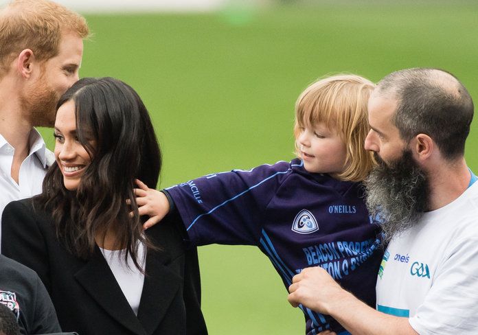 Meghan and Harry with a kid embed 1